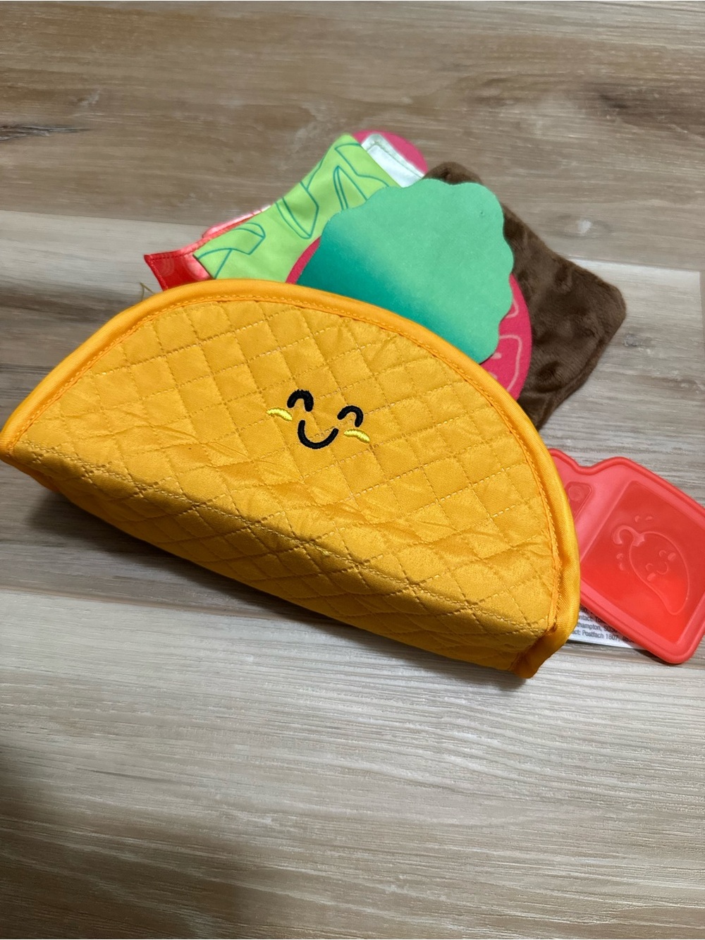 Melissa & Doug Soft Taco Fill & Spill sensory toy for infants.